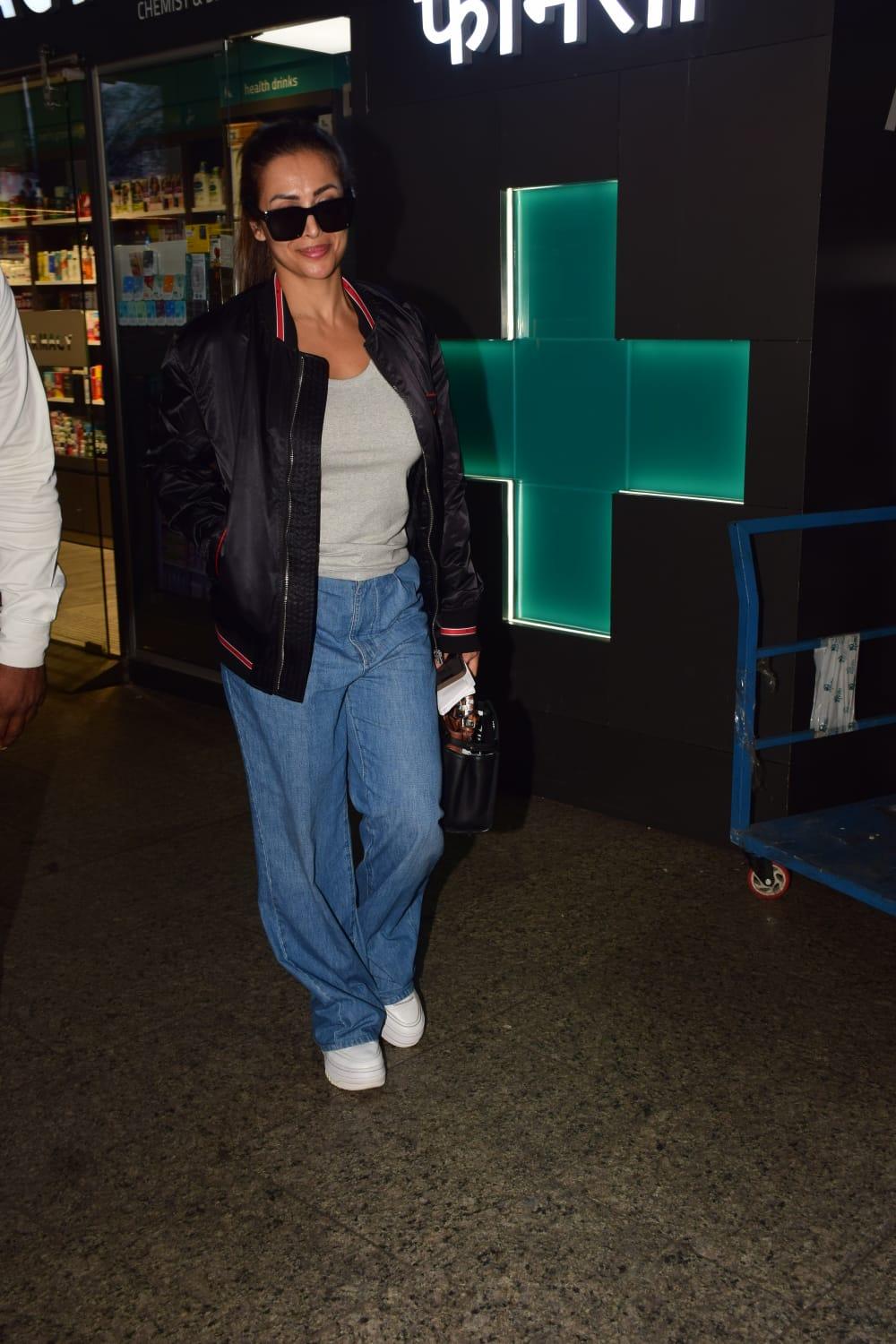 <p>Malaika Arora was snapped at the airport early this morning. She opted for a comfy and casual look in black varsity jacket with a white tank top underneath with blue denim.</p>